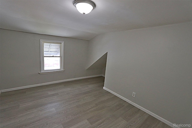 19444 Inkster Rd, Redford, MI 48240 - unfurnished room featuring vaulted ceiling, wood finished floors, and baseboards