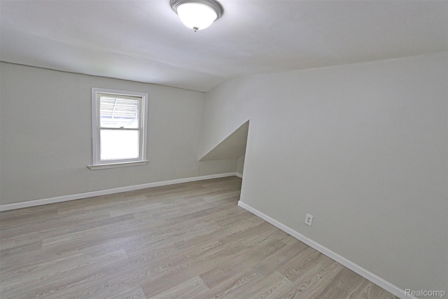 19444 Inkster Rd, Redford, MI 48240 - unfurnished room featuring vaulted ceiling, light wood-style flooring, and baseboards