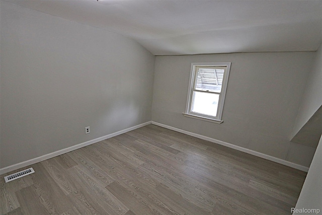 19444 Inkster Rd, Redford, MI 48240 - spare room with wood finished floors, lofted ceiling, and baseboards