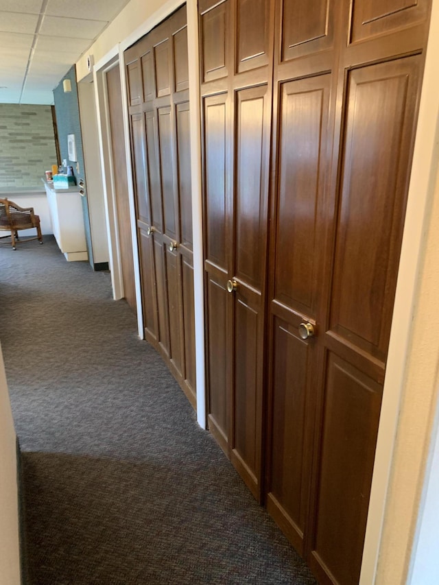 34203 Tomahawk St, Westland, MI 48185 - hallway featuring dark colored carpet and a paneled ceiling