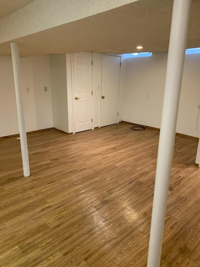 34203 Tomahawk St, Westland, MI 48185 - finished basement featuring light wood-style floors and a textured ceiling