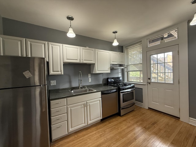 469 W Willis St Unit 4, Detroit, MI 48201 - kitchen featuring stainless steel appliances, a sink, dark countertops, light wood-style floors, and white cabinets