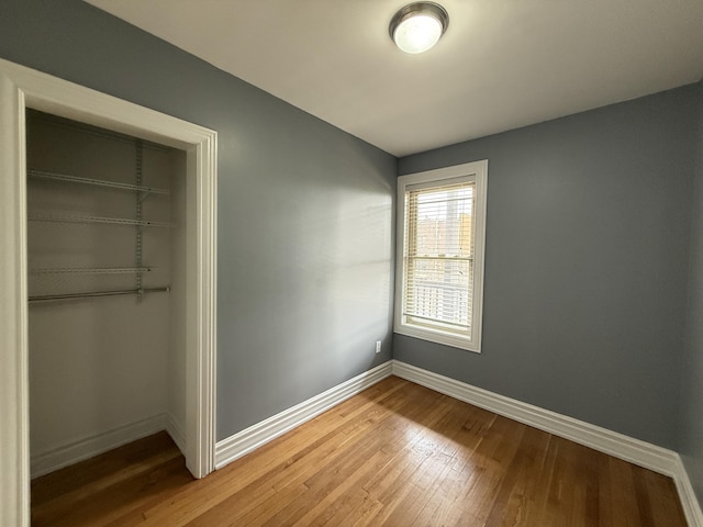 469 W Willis St Unit 4, Detroit, MI 48201 - unfurnished bedroom with light wood-style floors, baseboards, and a closet