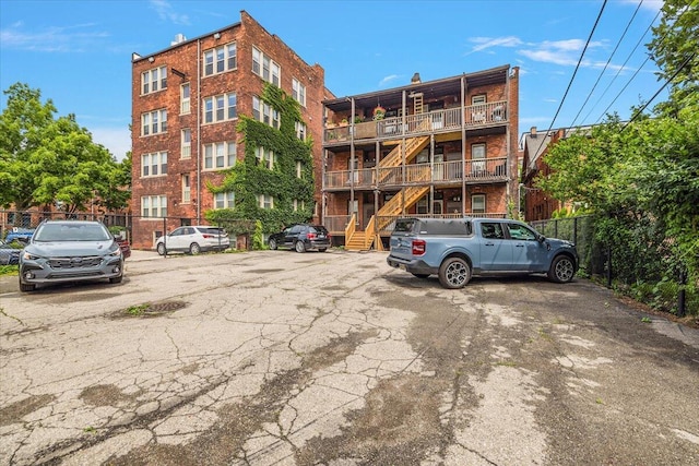 469 W Willis St Unit 4, Detroit, MI 48201 - view of apartment building / complex featuring stairs and uncovered parking