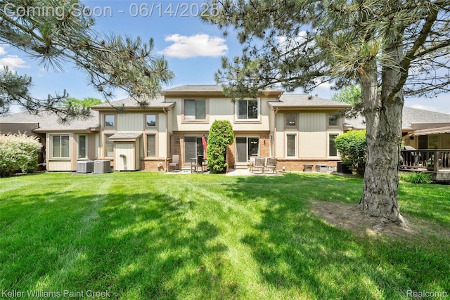 46860 High Meadows Ct, Macomb, MI 48044 - rear view of house with brick siding and a lawn