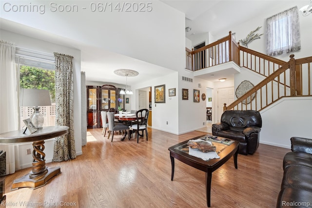 46860 High Meadows Ct, Macomb, MI 48044 - living area with a chandelier, light wood finished floors, and stairs