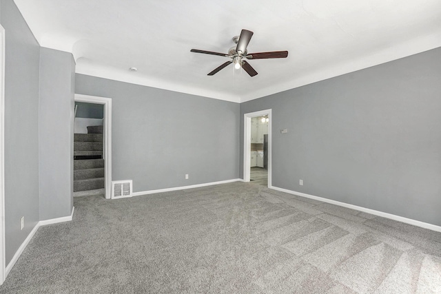 1169 3rd St NW, Grand Rapids, MI 49504 - carpeted empty room with a ceiling fan, baseboards, and stairs