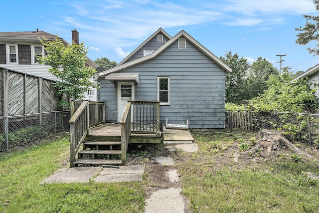 1169 3rd St NW, Grand Rapids, MI 49504 - rear view of property featuring a wooden deck and a chimney