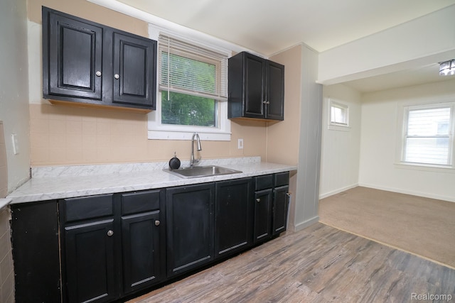 17376 Fielding St, Detroit, MI 48219 - kitchen with dark cabinetry, healthy amount of natural light, and light wood-style flooring