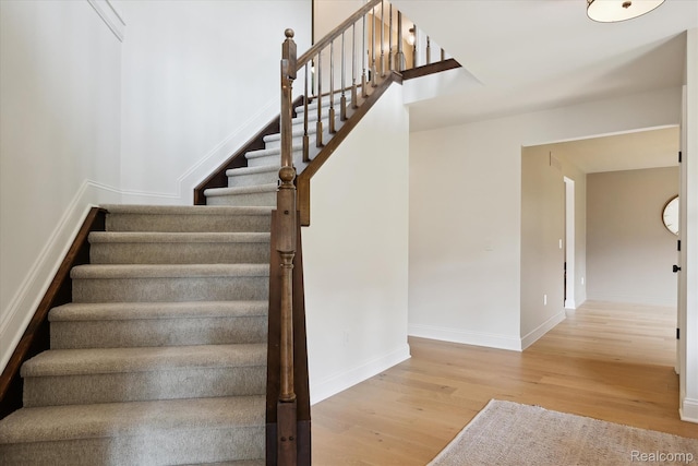 5695 Deerwood, Commerce Twp, MI 48382 - staircase with wood finished floors and baseboards