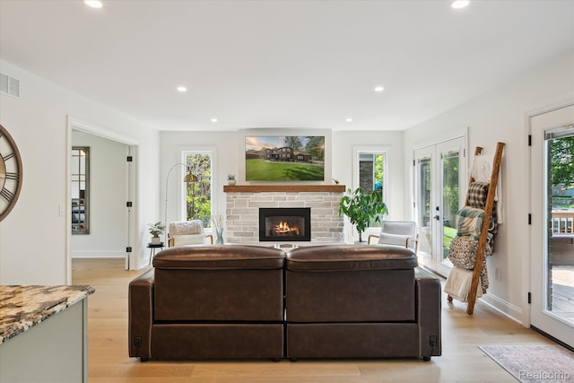 5695 Deerwood, Commerce Twp, MI 48382 - living room with recessed lighting, light wood-type flooring, a fireplace, and french doors