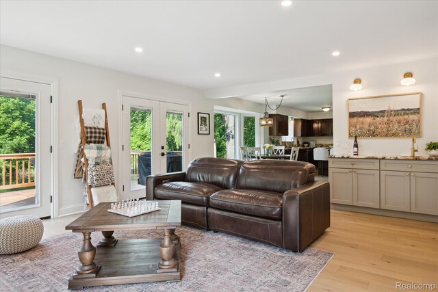 5695 Deerwood, Commerce Twp, MI 48382 - living area with plenty of natural light, light wood-style floors, and recessed lighting