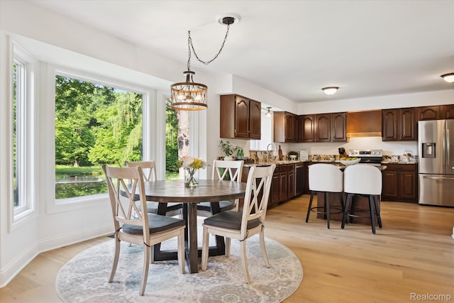 5695 Deerwood, Commerce Twp, MI 48382 - dining room featuring a chandelier, plenty of natural light, and light wood finished floors