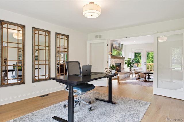 5695 Deerwood, Commerce Twp, MI 48382 - office featuring french doors, a warm lit fireplace, and wood finished floors