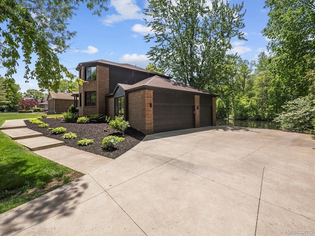5695 Deerwood, Commerce Twp, MI 48382 - view of home's exterior featuring brick siding and an attached garage