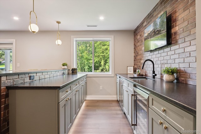 5695 Deerwood, Commerce Twp, MI 48382 - kitchen with beverage cooler, dark countertops, wood finished floors, plenty of natural light, and recessed lighting
