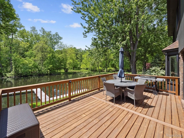 5695 Deerwood, Commerce Twp, MI 48382 - wooden deck featuring outdoor dining area and a water view