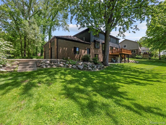 5695 Deerwood, Commerce Twp, MI 48382 - rear view of property with a wooden deck, a lawn, and brick siding
