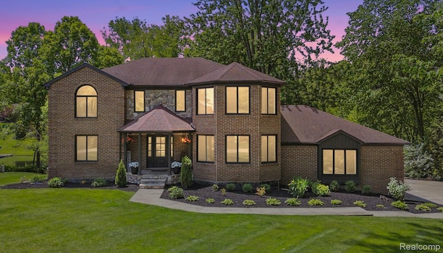 5695 Deerwood, Commerce Twp, MI 48382 - view of front facade with a front lawn, brick siding, and roof with shingles