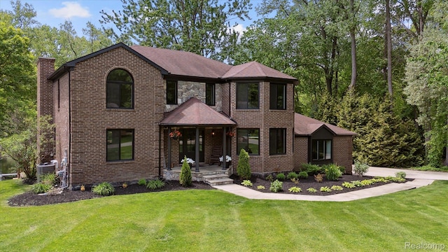 5695 Deerwood, Commerce Twp, MI 48382 - view of front of home featuring a chimney, a front yard, and brick siding