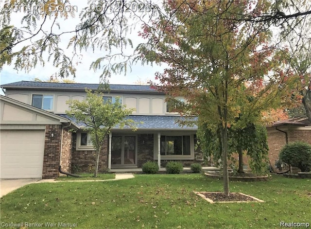 7302 Parkway Ct, Canton, MI 48187 - view of front facade featuring a garage, a front yard, brick siding, and driveway