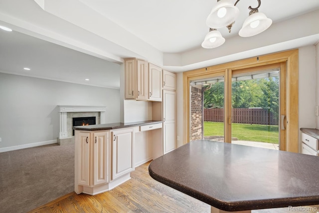 7302 Parkway Ct, Canton, MI 48187 - kitchen featuring dark countertops, a high end fireplace, a peninsula, light wood-style floors, and recessed lighting