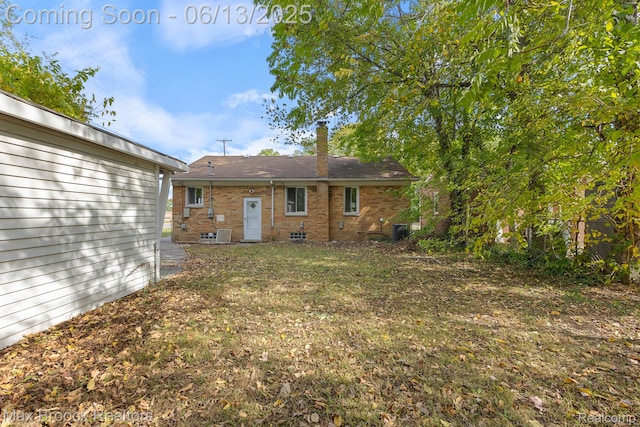 24811 Sherman St, Oak Park, MI 48237 - back of house with a chimney, brick siding, and central air condition unit