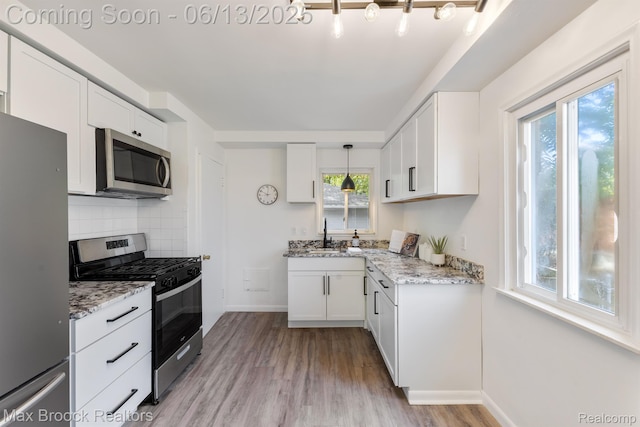 24811 Sherman St, Oak Park, MI 48237 - kitchen featuring stainless steel appliances, healthy amount of natural light, and light wood-type flooring