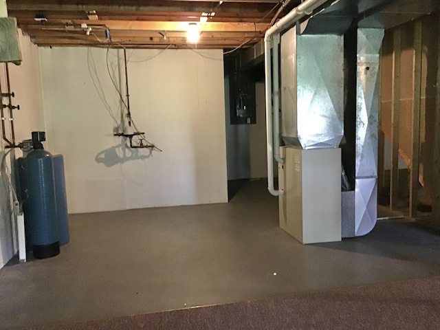 1077 Wedgewood Dr, Plainwell, MI 49080 - unfinished below grade area with heating unit and a water softener