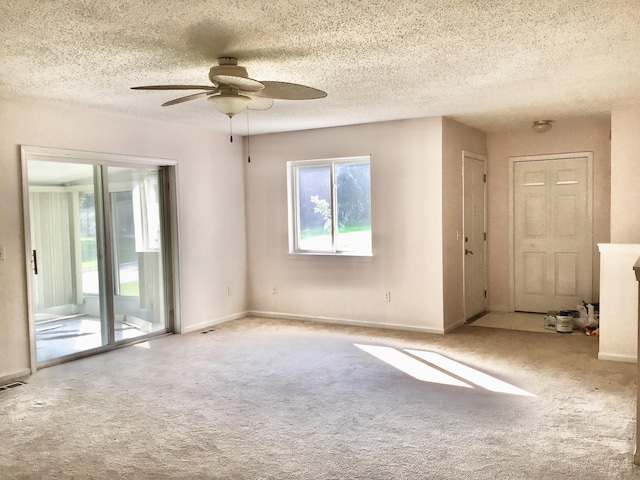 1077 Wedgewood Dr, Plainwell, MI 49080 - spare room featuring ceiling fan, carpet flooring, a textured ceiling, and baseboards