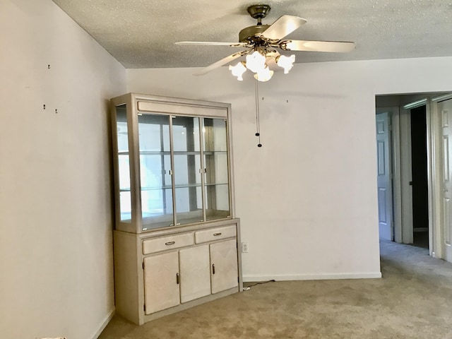 1077 Wedgewood Dr, Plainwell, MI 49080 - spare room with light carpet, a ceiling fan, a textured ceiling, and baseboards
