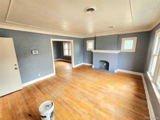 16612 Ilene St, Detroit, MI 48221 - unfurnished living room with healthy amount of natural light, a fireplace with flush hearth, wood-type flooring, and ornamental molding