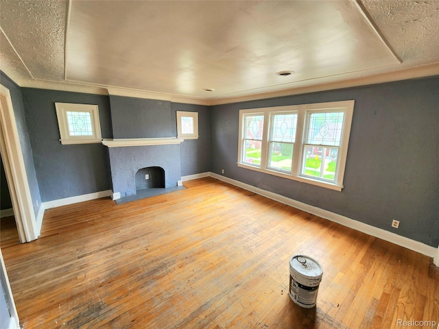 16612 Ilene St, Detroit, MI 48221 - unfurnished living room with healthy amount of natural light, hardwood / wood-style floors, and a fireplace with flush hearth