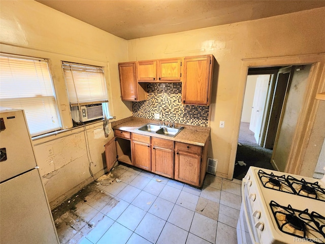 16612 Ilene St, Detroit, MI 48221 - kitchen with cooling unit, white appliances, decorative backsplash, light countertops, and brown cabinets