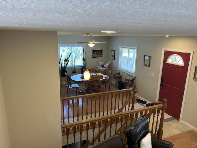 112 Kilkenny Dr, Onsted, MI 49265 - entryway featuring healthy amount of natural light, a textured ceiling, a ceiling fan, baseboards, and stairs