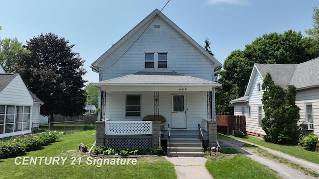 408 S Alp St, Bay City, MI 48706 - view of front of home with covered porch, cooling unit, and roof with shingles