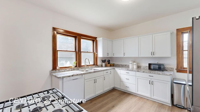 408 S Alp St, Bay City, MI 48706 - kitchen with black microwave, white dishwasher, white cabinetry, and light wood-type flooring