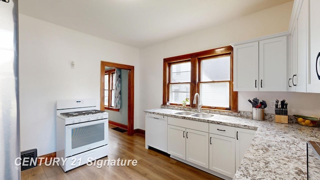 408 S Alp St, Bay City, MI 48706 - kitchen featuring white appliances, white cabinets, and wood finished floors