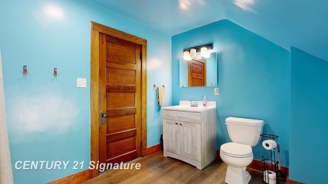 408 S Alp St, Bay City, MI 48706 - bathroom featuring wood finished floors, vanity, and lofted ceiling