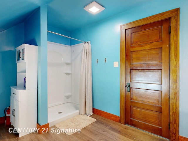 408 S Alp St, Bay City, MI 48706 - bathroom featuring wood finished floors and a shower stall