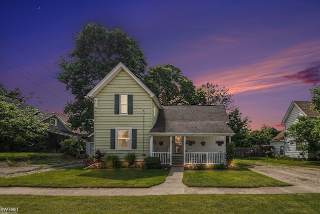 103 Lenawee St, Durand, MI 48429 - traditional home with a porch, a front yard, and driveway