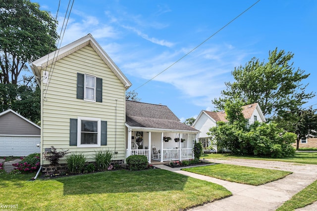 103 Lenawee St, Durand, MI 48429 - traditional-style home featuring covered porch, a front lawn, a detached garage, and an outbuilding