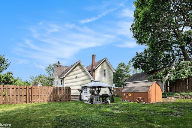 103 Lenawee St, Durand, MI 48429 - back of house with a gazebo and a chimney