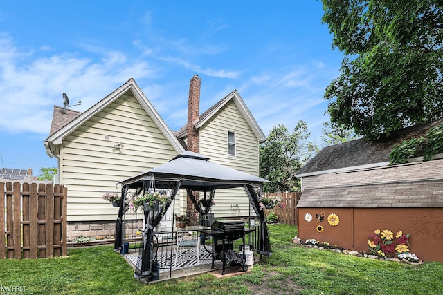 103 Lenawee St, Durand, MI 48429 - back of property featuring a gazebo, a patio, and a chimney