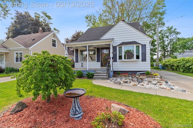 24921 Notre Dame St, Dearborn, MI 48124 - bungalow-style house featuring covered porch, a front yard, and roof with shingles