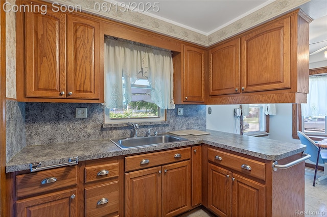 24921 Notre Dame St, Dearborn, MI 48124 - kitchen with brown cabinetry, a peninsula, and tasteful backsplash