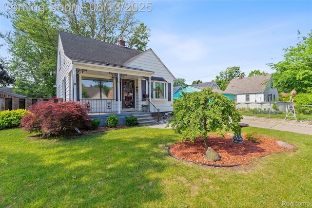 24921 Notre Dame St, Dearborn, MI 48124 - bungalow with a porch, a front lawn, a chimney, and a shingled roof
