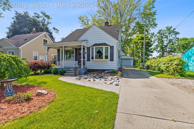 24921 Notre Dame St, Dearborn, MI 48124 - bungalow with a front yard, covered porch, an outbuilding, a chimney, and a garage