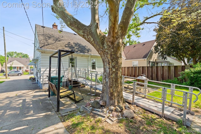 24921 Notre Dame St, Dearborn, MI 48124 - rear view of property with roof with shingles and a chimney