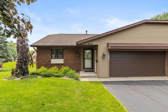 5157 Cliff Ct Unit 54, Hudsonville, MI 49426 - view of front facade featuring a front lawn, brick siding, roof with shingles, and an attached garage